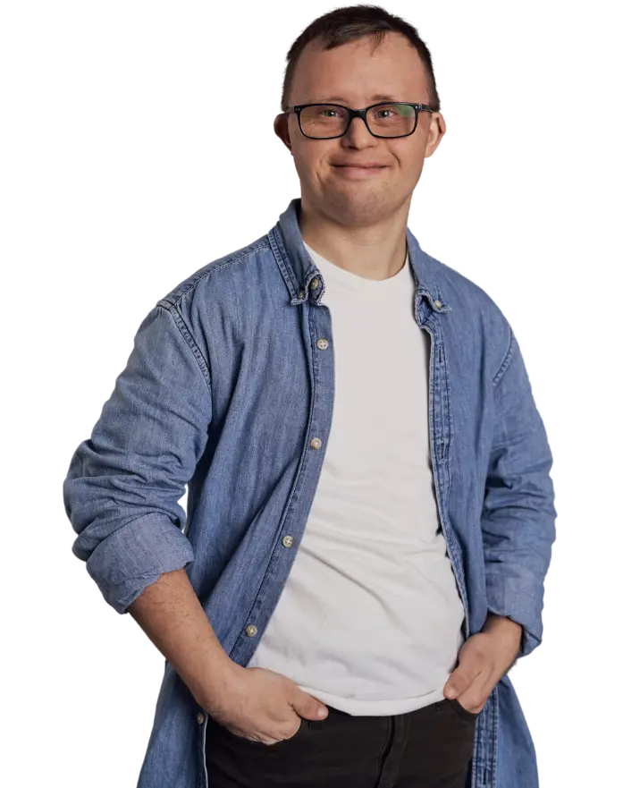 Happy disabled boy smiling at camera wearing blue denim shirt with hands in pockets